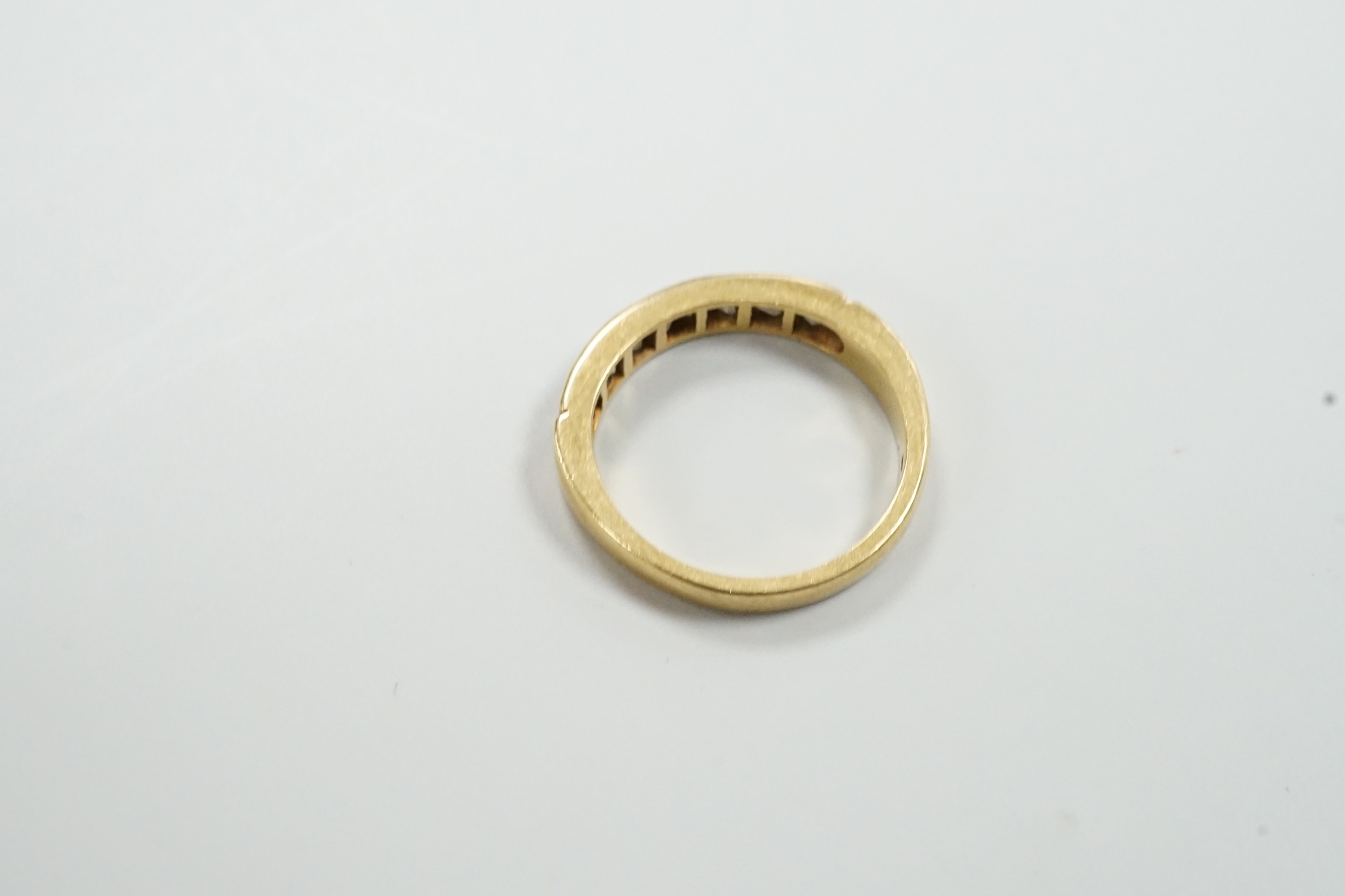 A modern 18ct gold and eight stone princess? cut diamond set half hoop ring, size M/N, gross weight 3.8 grams.